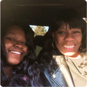 Karelle and her mom sitting in a career taking a selfie.